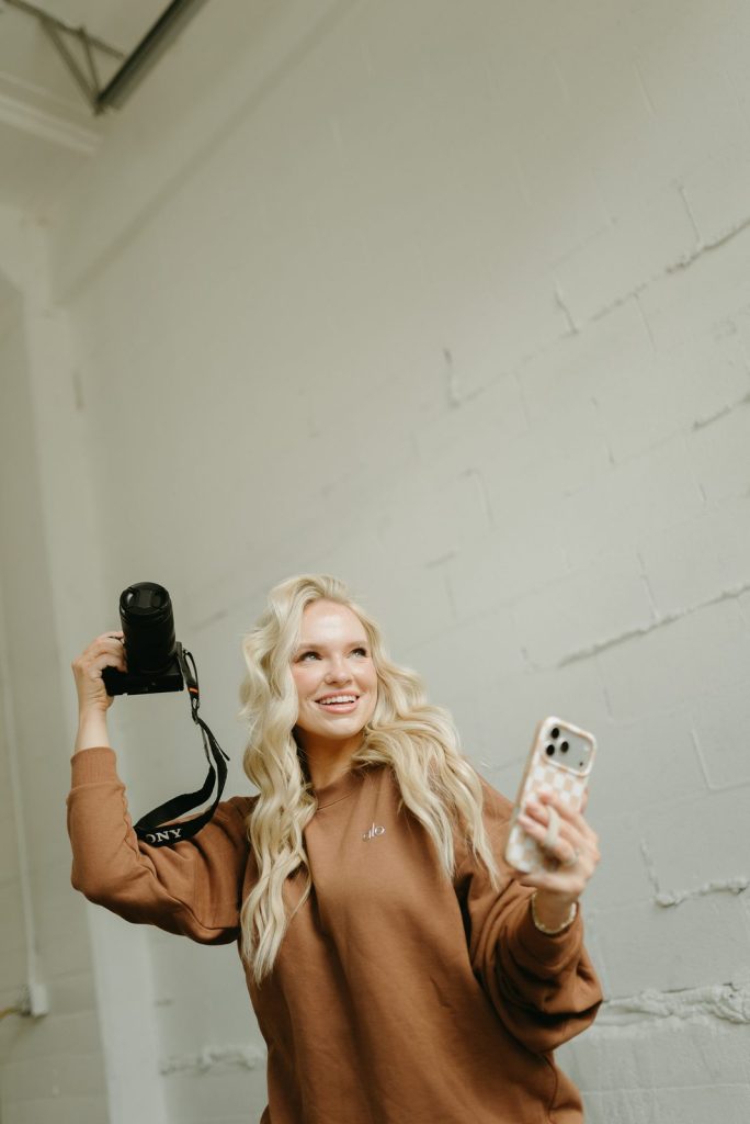 Riley creating content with a camera and phone