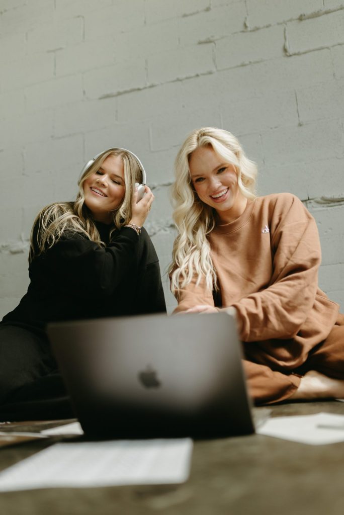 Paige and Riley working together on a laptop